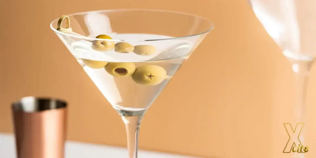 A glass with Vodka Martini on orange background.